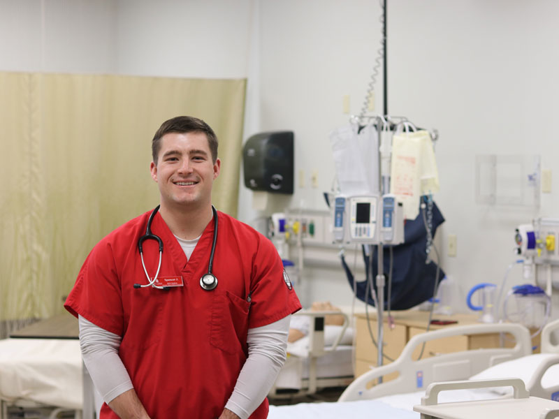 An Army ROTC nurse in a hospital room smiling