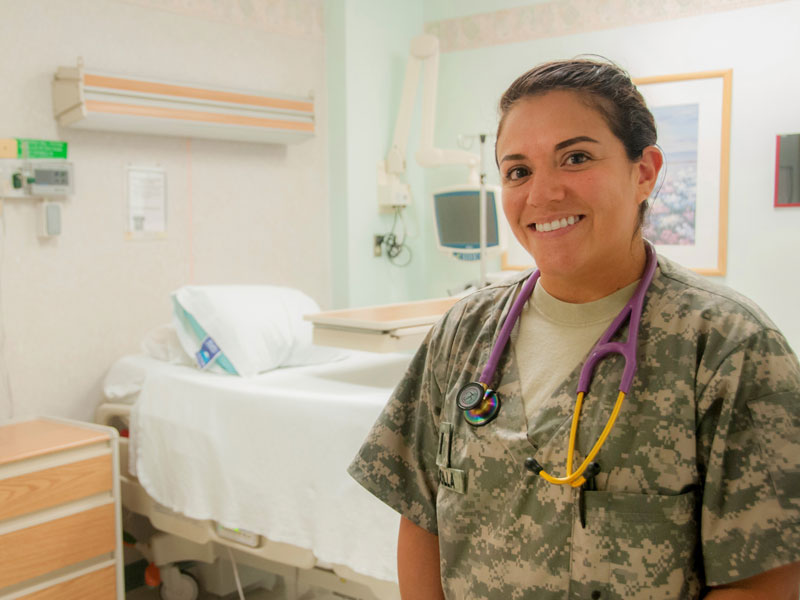 An Army ROTC nurse in a hospital room smiling